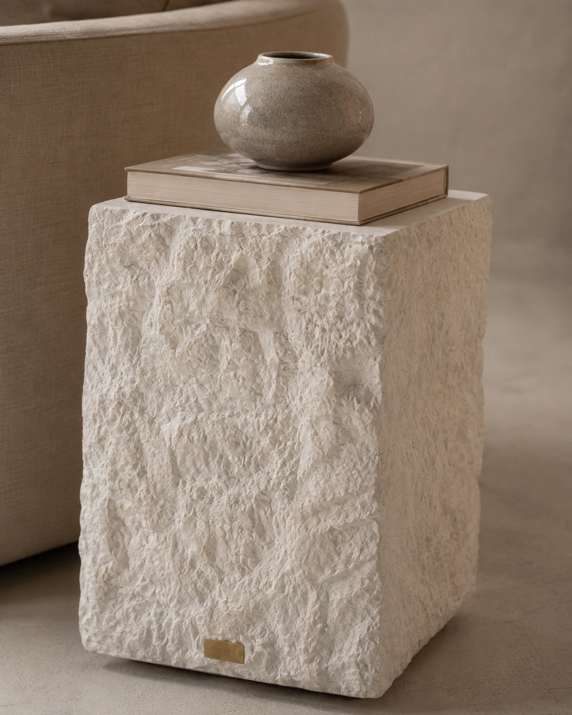 Close detail of the hand-applied mineral plaster texture on the side table