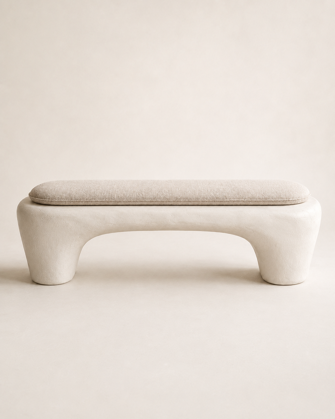 Sculptural Wabi-Sabi Plaster Bench with a removable linen-look cushion and matte limestone-inspired base
