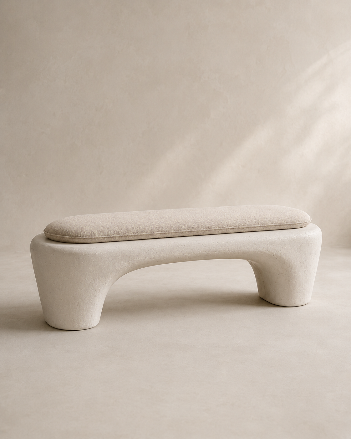 The curved arch form of the Wabi-Sabi Plaster Bench, hand-finished in mineral plaster