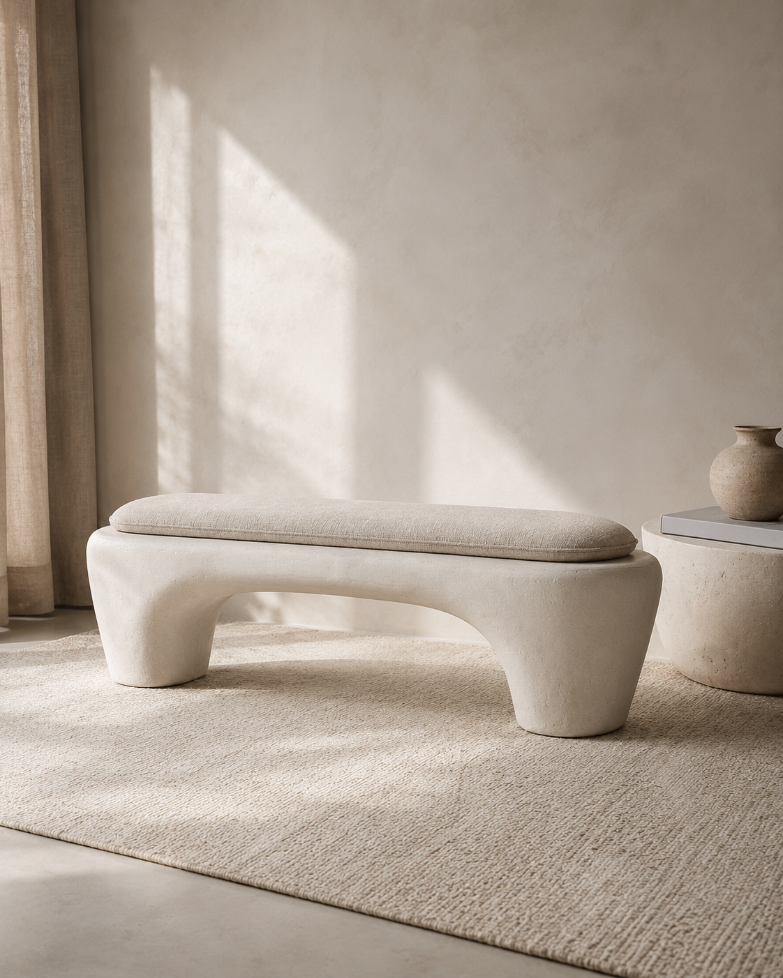 Sculptural Wabi-Sabi Plaster Bench with a removable linen-look cushion and matte limestone-inspired base