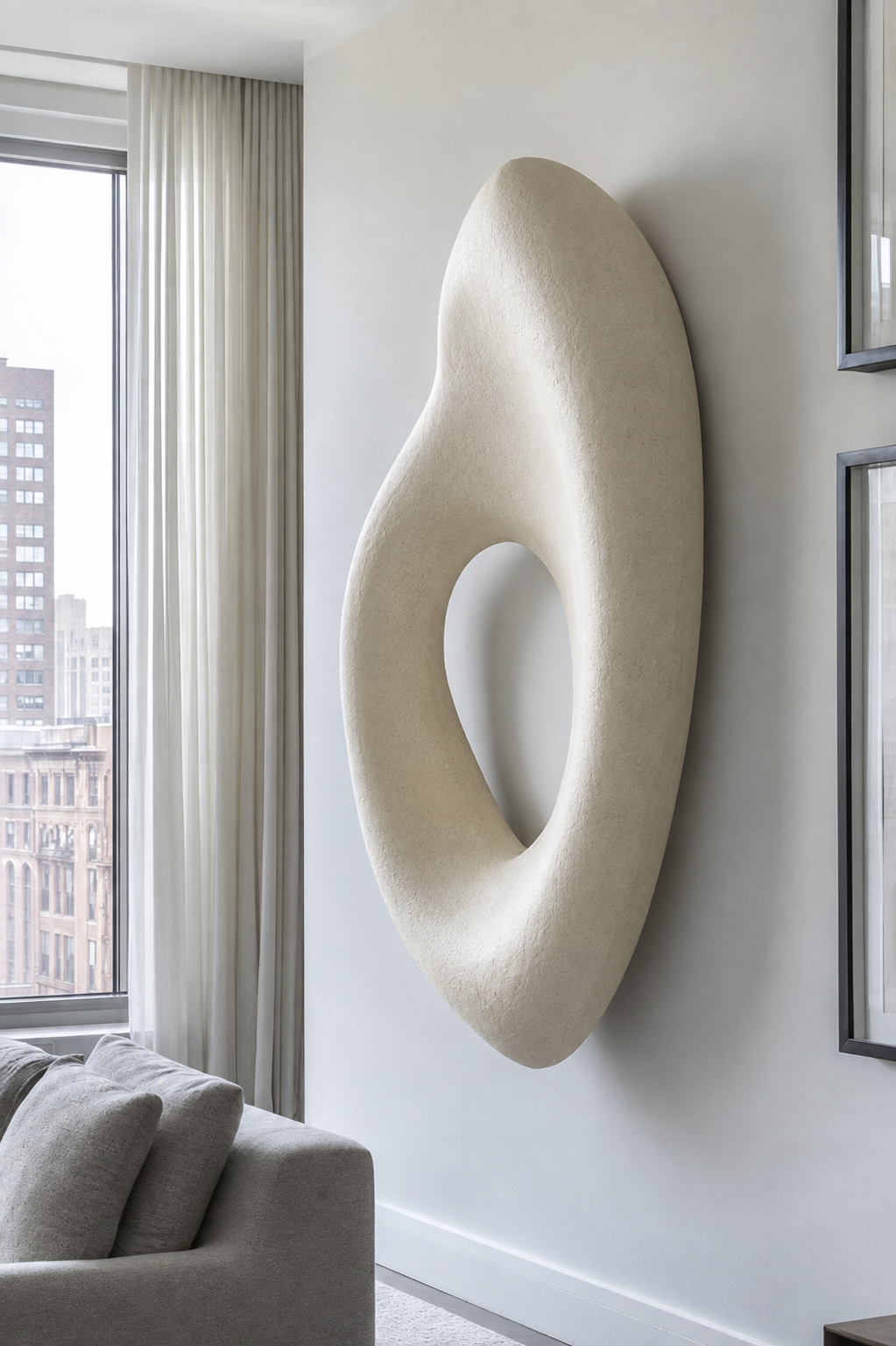 Forma Void large organic wall sculpture in hand-finished mineral plaster, with a carved negative-space opening