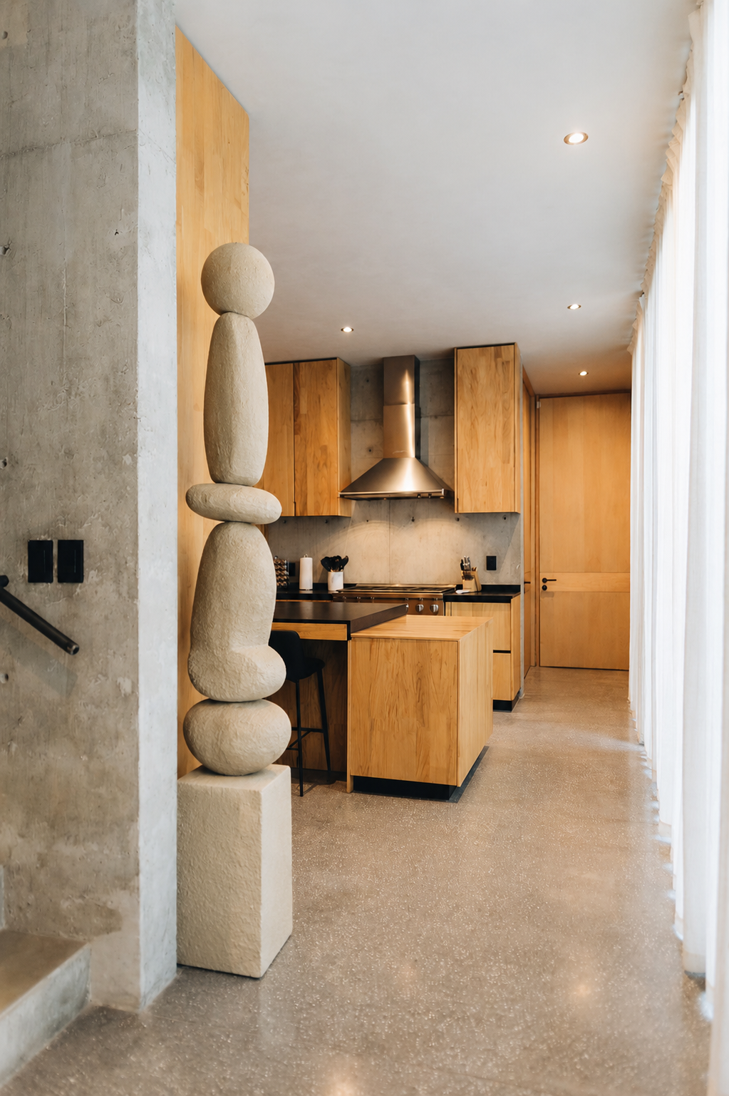 Handcrafted stone-look totem sculpture in an entrance hall