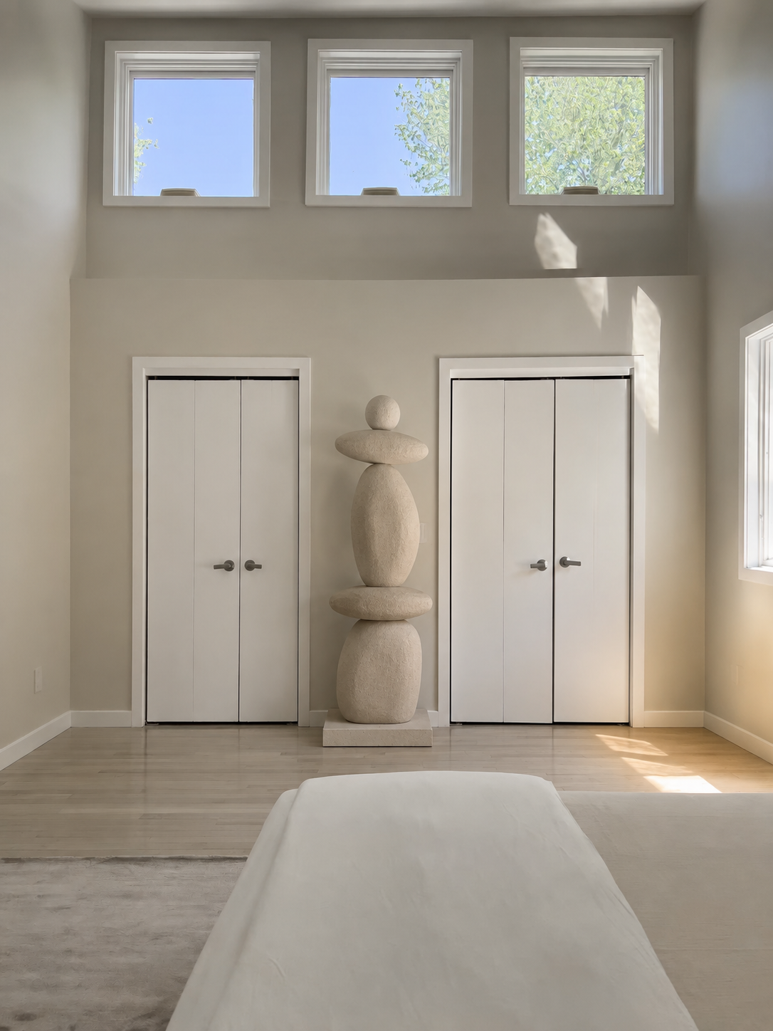 Mono Aurel sculptural stacked totem at a residential arched entrance